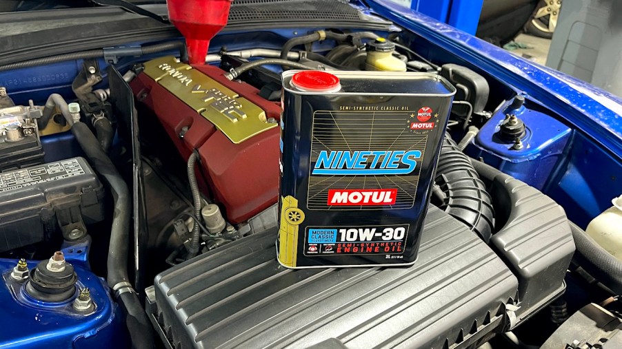 A can of Motul Modern Classic oil sitting on the engine of a Honda S2000
