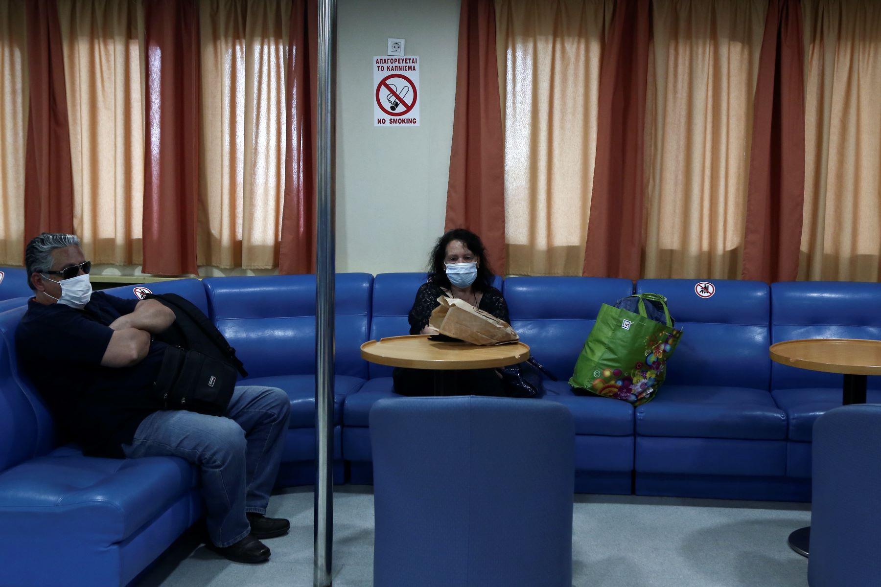 Passengers on boat seats on a trip to the Cyclades islands in Greece wearing masks, preventative measure of mold