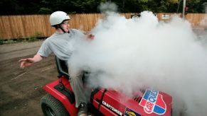 A smoking riding lawn mower during a race at the Saco Pathfinders Snowmobile Club