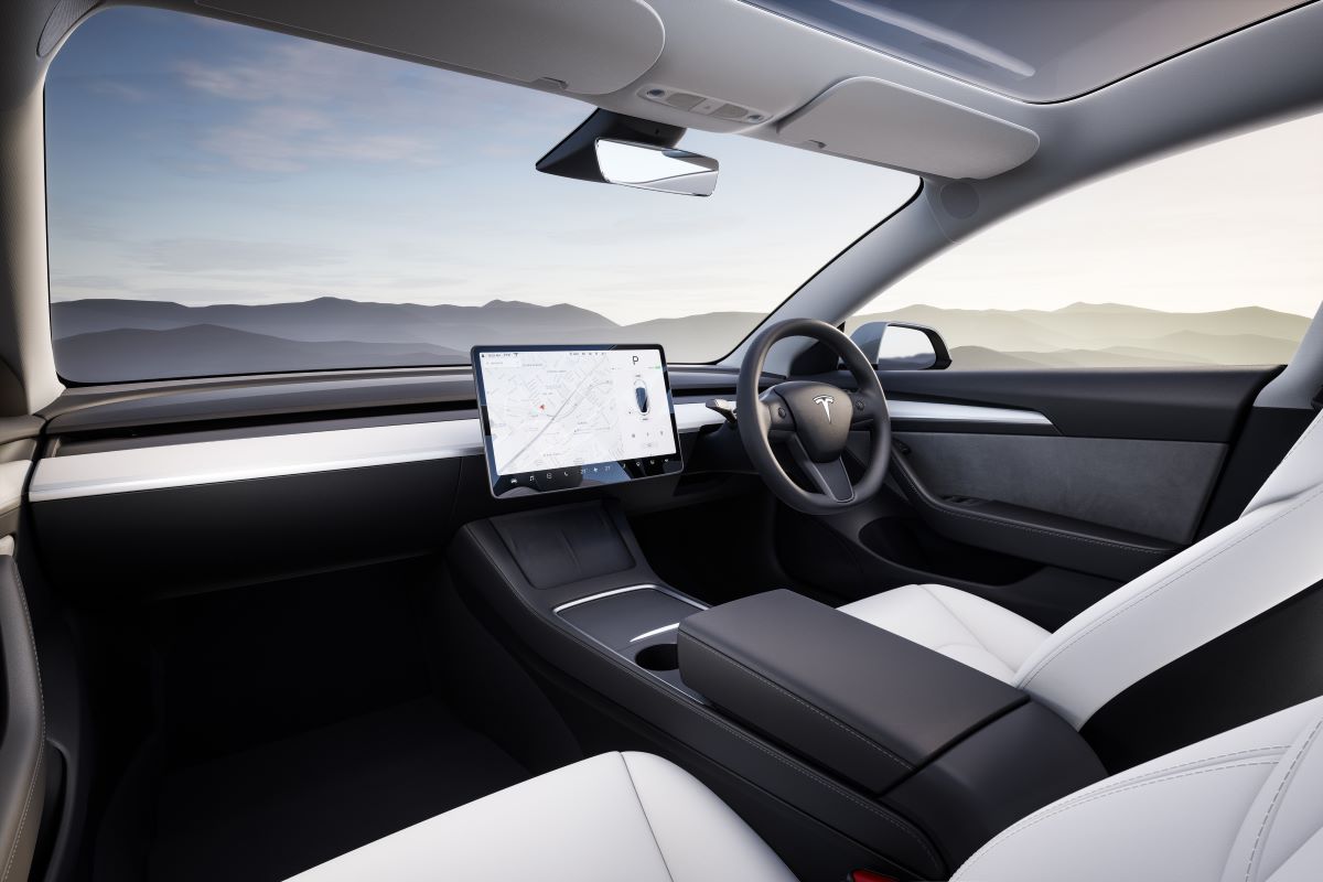 The interior of a Tesla Model 3 electric car in white and black