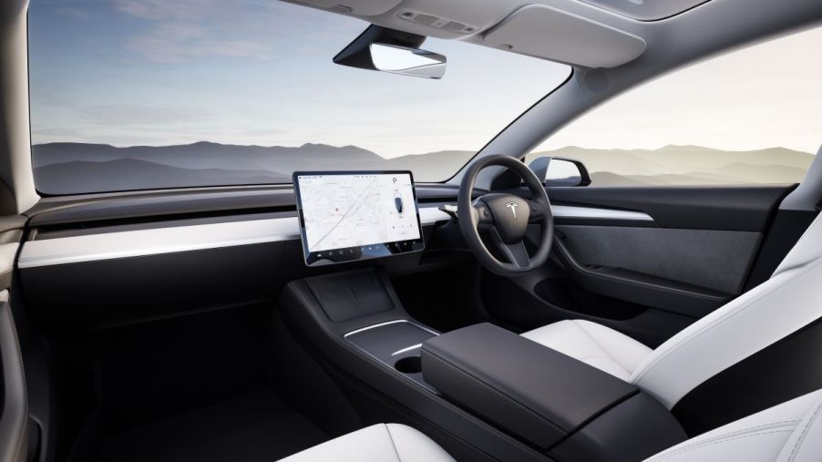 The interior of a Tesla Model 3 electric car in white and black