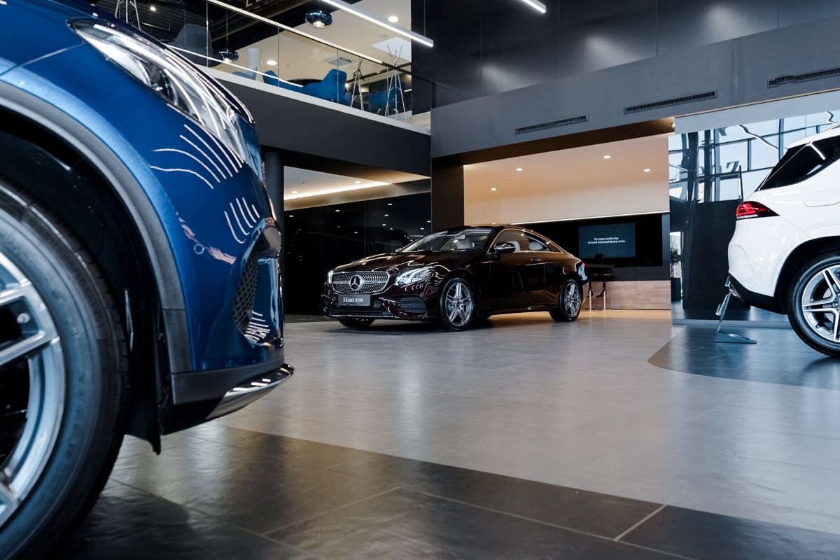 Cars in a dealership showroom. Used car prices are going down, but still very high