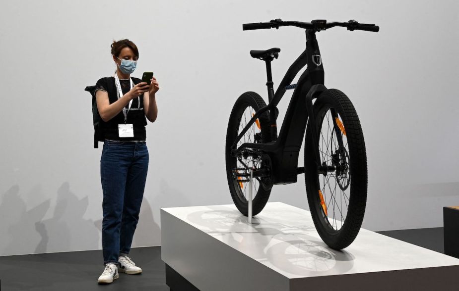 A woman takes pictures of a Serial 1 eBike by Harley-Davidson