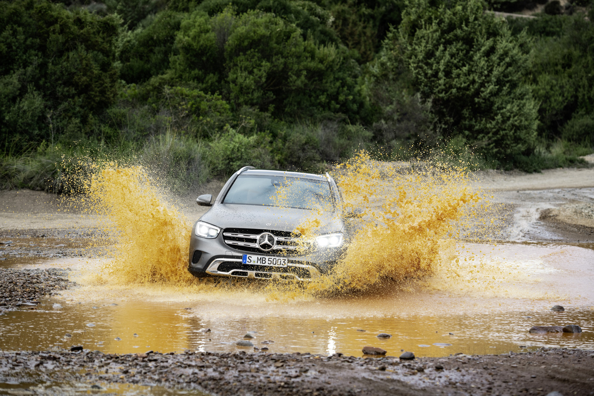 The new Mercedes-Benz GLC in in silver driving in the mud