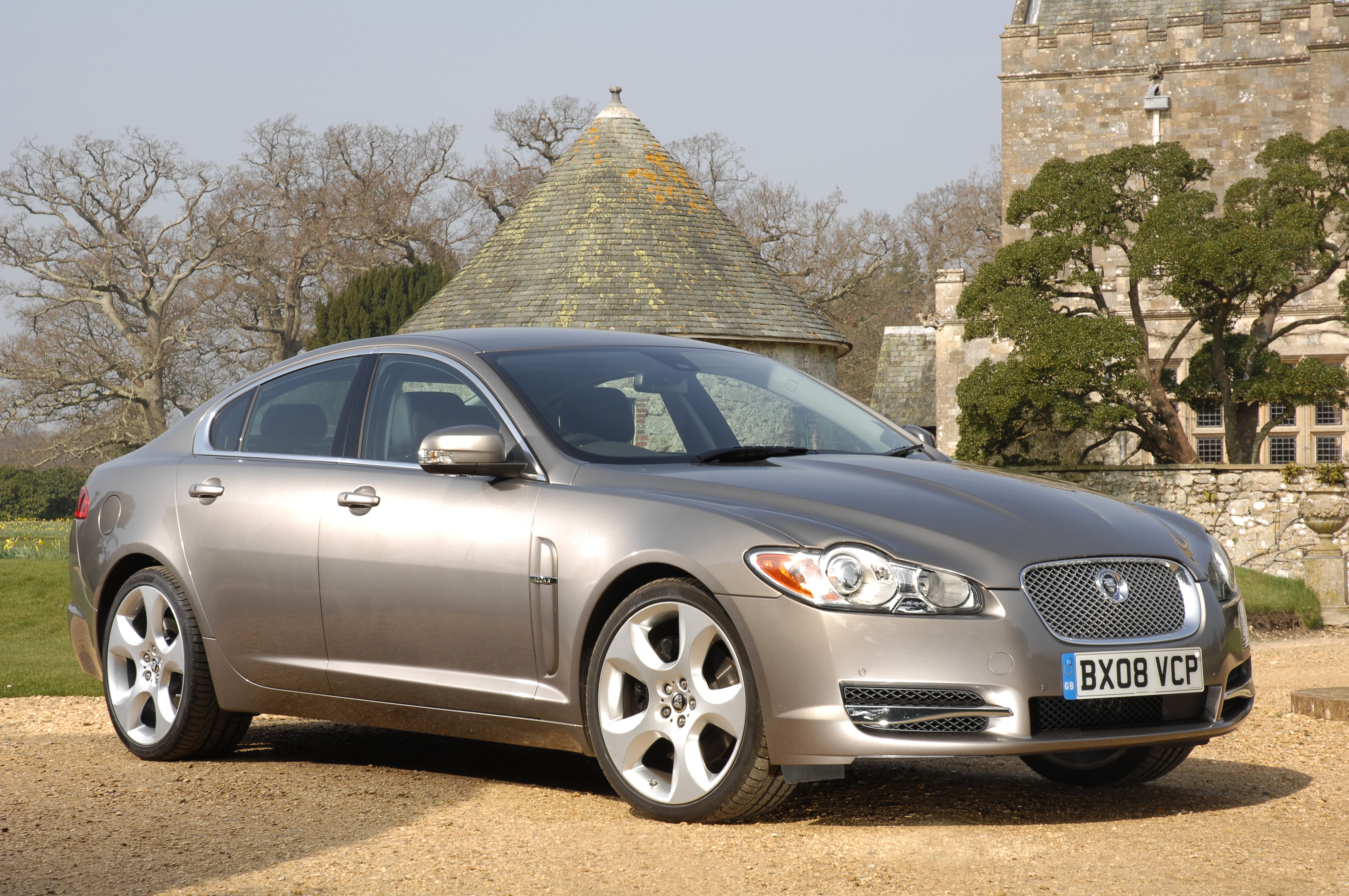 A silver 2009 Jaguar XF Supercharged in front of a castle