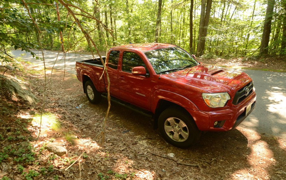 Red 2012 Toyota Tacoma in the woods