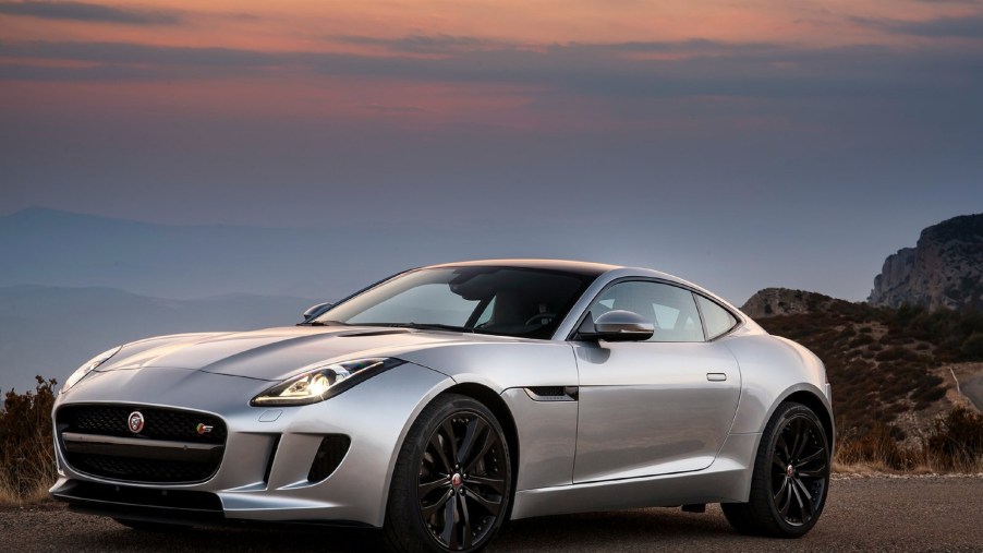 A silver 2016 Jaguar F-Type V6 S Coupe on a canyon road at sunset