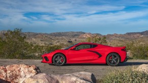 The side view of a red 2022 C8 Chevrolet Corvette Stingray on a desert road