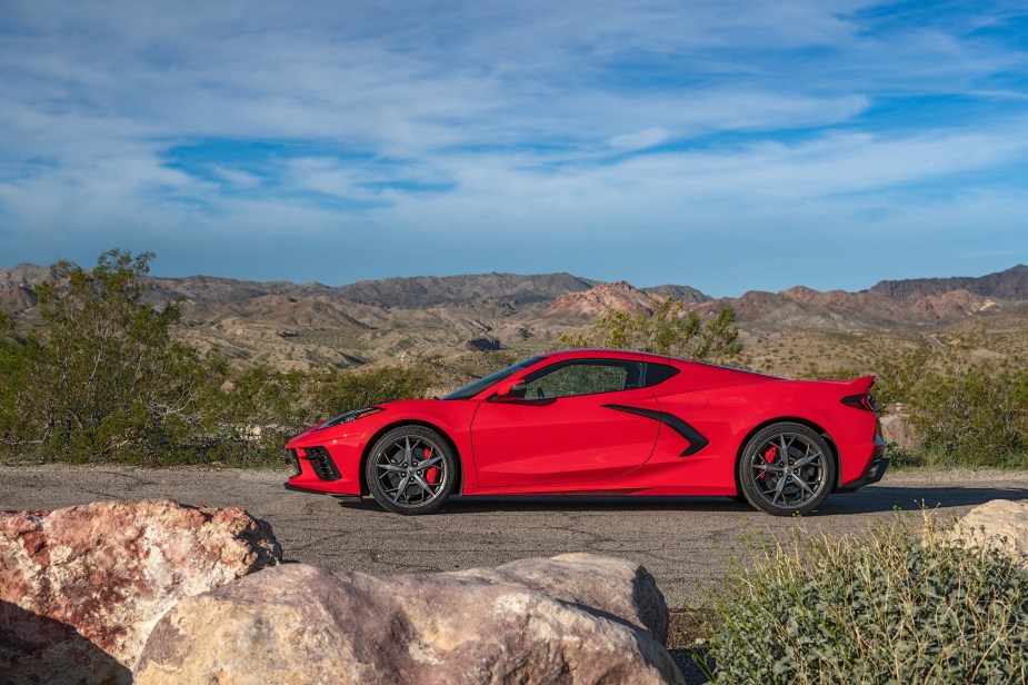 The side view of a red 2022 C8 Chevrolet Corvette Stingray on a desert road