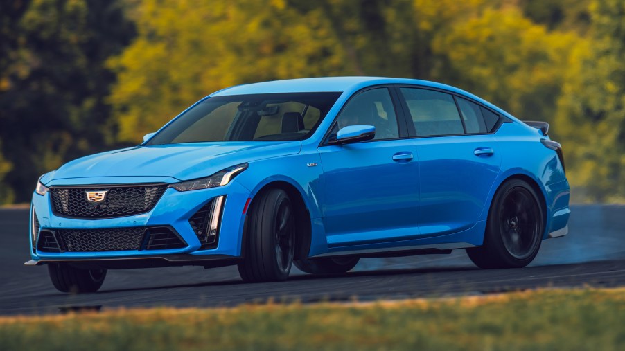 A blue 2022 Cadillac CT5-V Blackwing sliding around a track