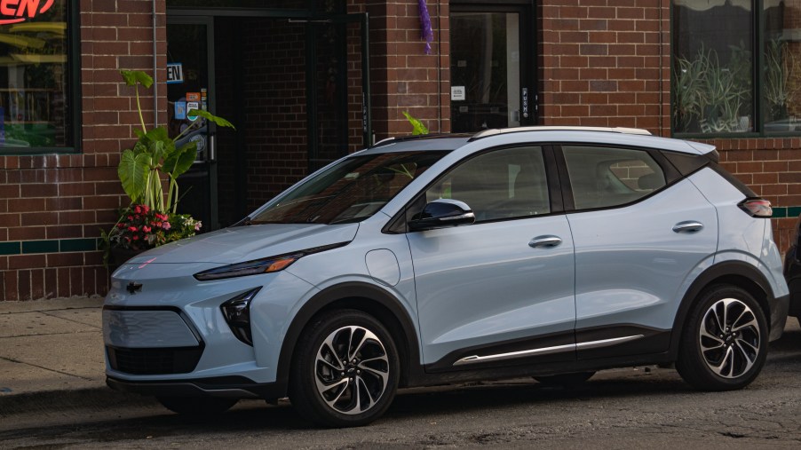 The front 3/4 view of a light-blue 2022 Chevrolet Bolt EUV Premier on a Chicago city street