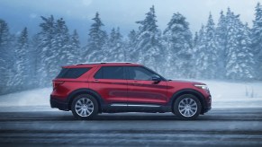 A red 2022 Ford Explorer midsize SUV. Is the most popular trim XLT or experts favorite Limited better?