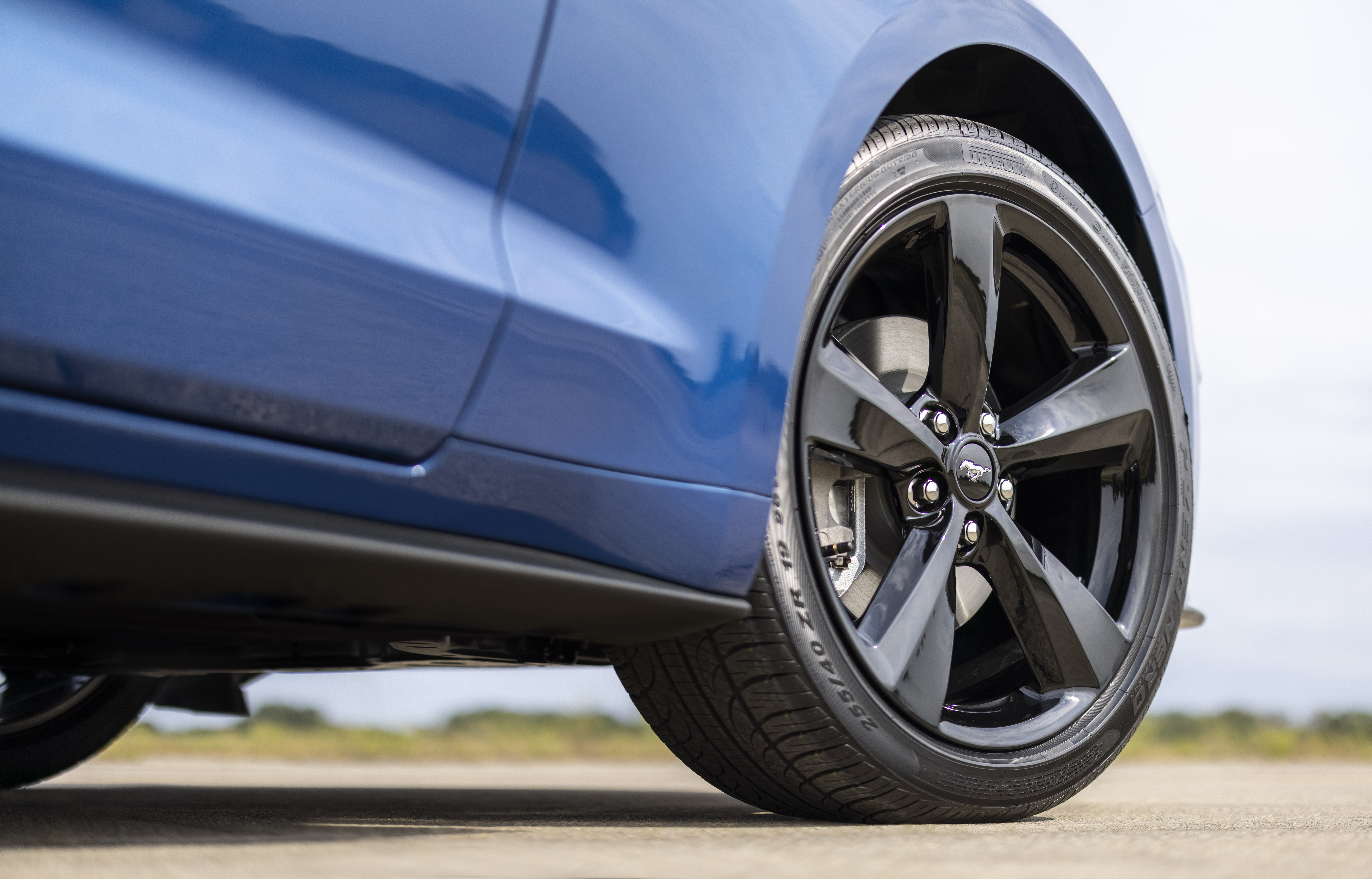 Close up on the tire of a blue 2022 Ford Mustang Stealth Edition
