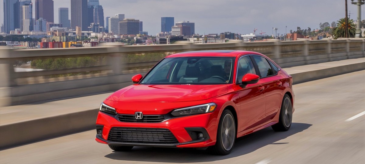 A red 2022 Honda Civic Sedan Touring on the highway
