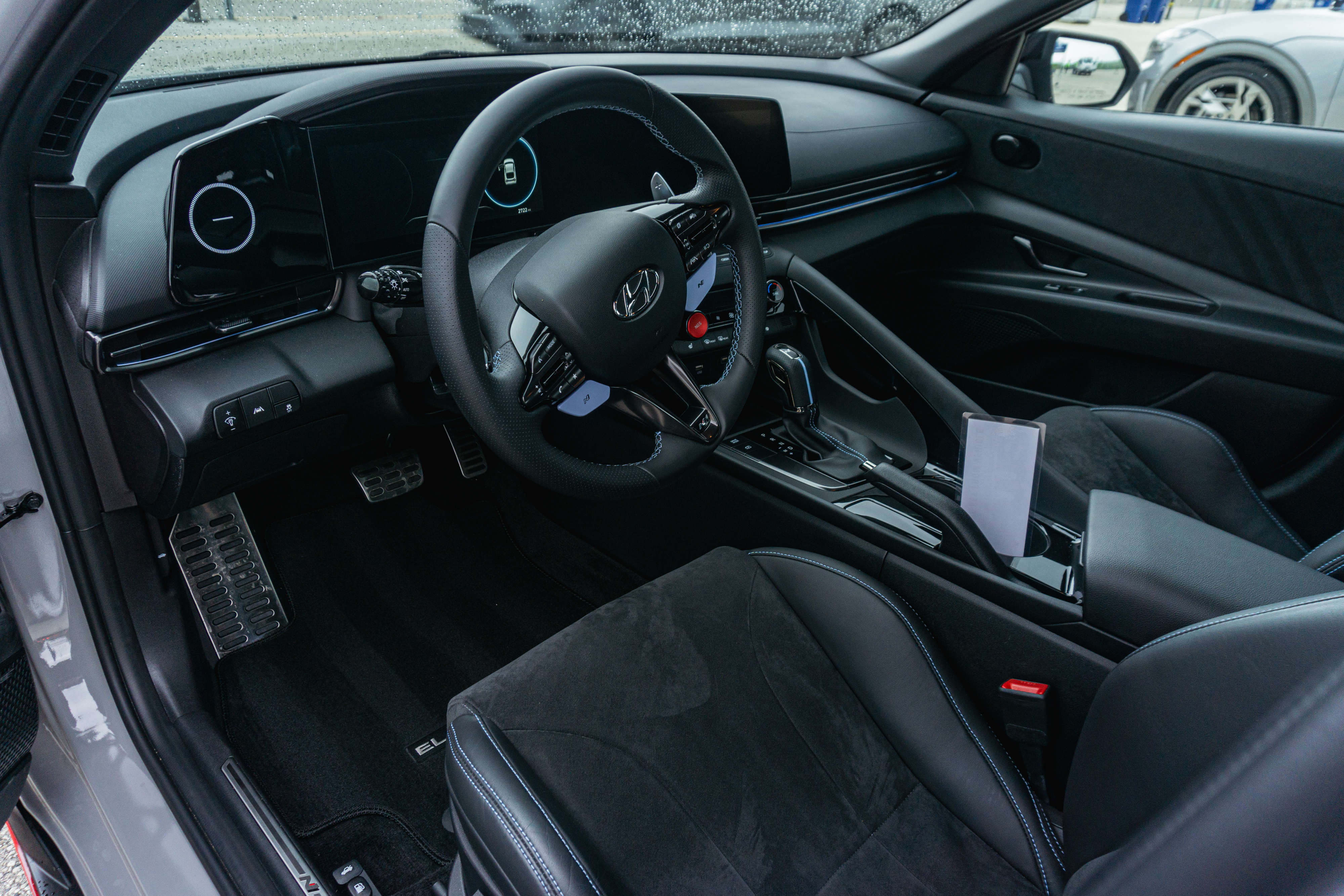 The black-and-blue front seats and dashboard of a 2022 Hyundai Elantra N DCT