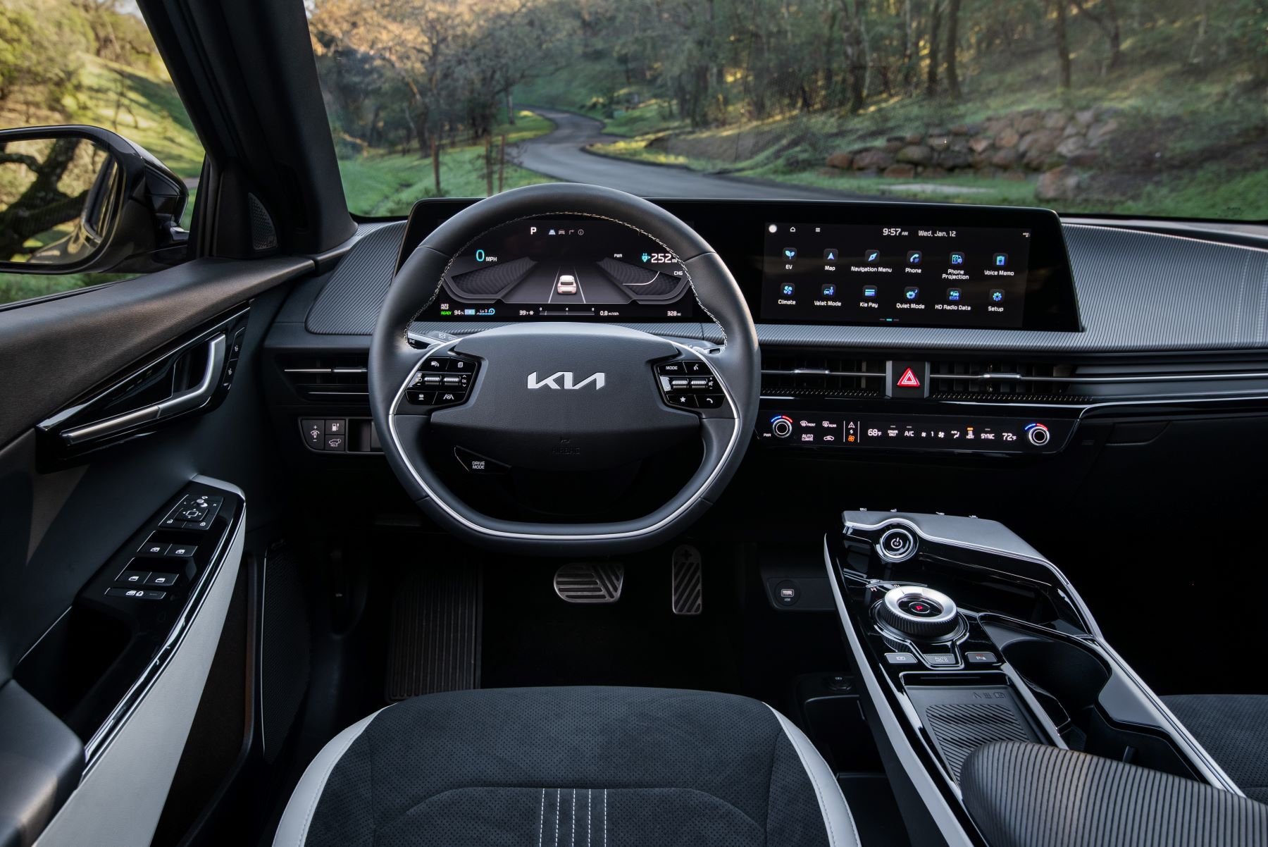 A shot of the interior of the 2022 Kia EV6 electric SUV featuring the steering wheel and infotainment system display