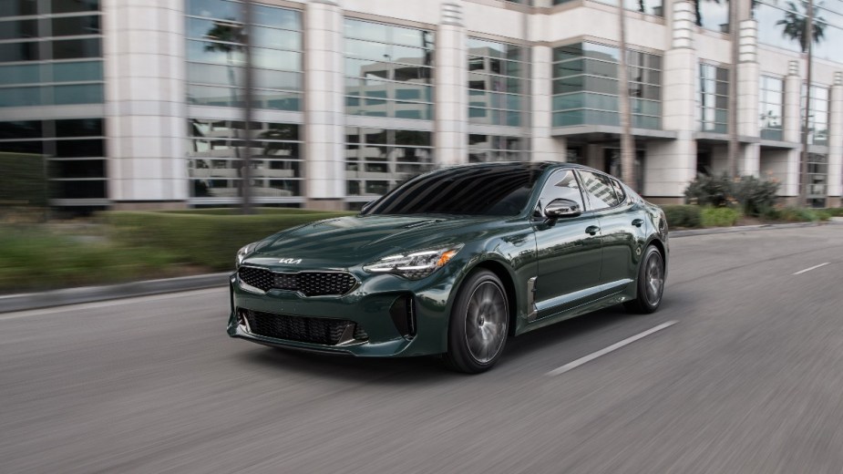 a green 2022 kia stinger, a sports car with a large hatchback at the rear, perfect for golfers