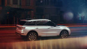 A side shot of a silver gray 2022 Lincoln Corsair luxury compact SUV parked on the side of a street