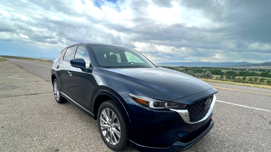 A front corner view of the 2022 Mazda CX-5 Turbo Signature on an open road.