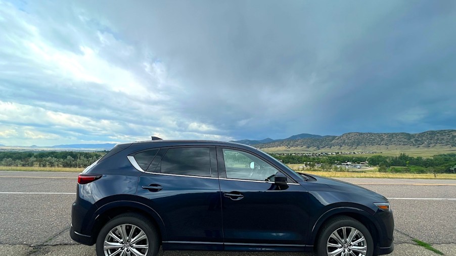 2022 Mazda CX-5 Turbo Signature side view on an open road