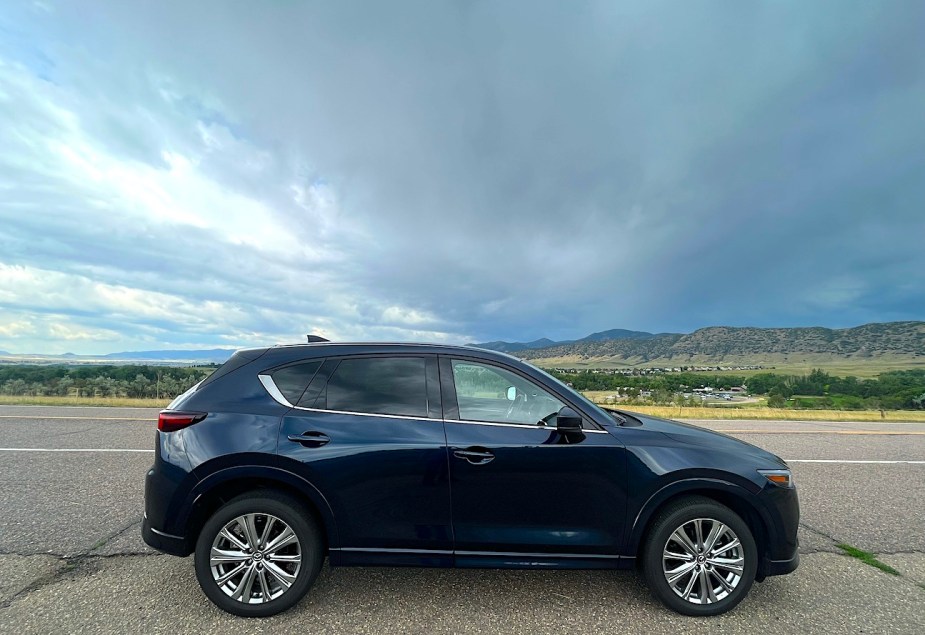 2022 Mazda CX-5 Turbo Signature side view on an open road
