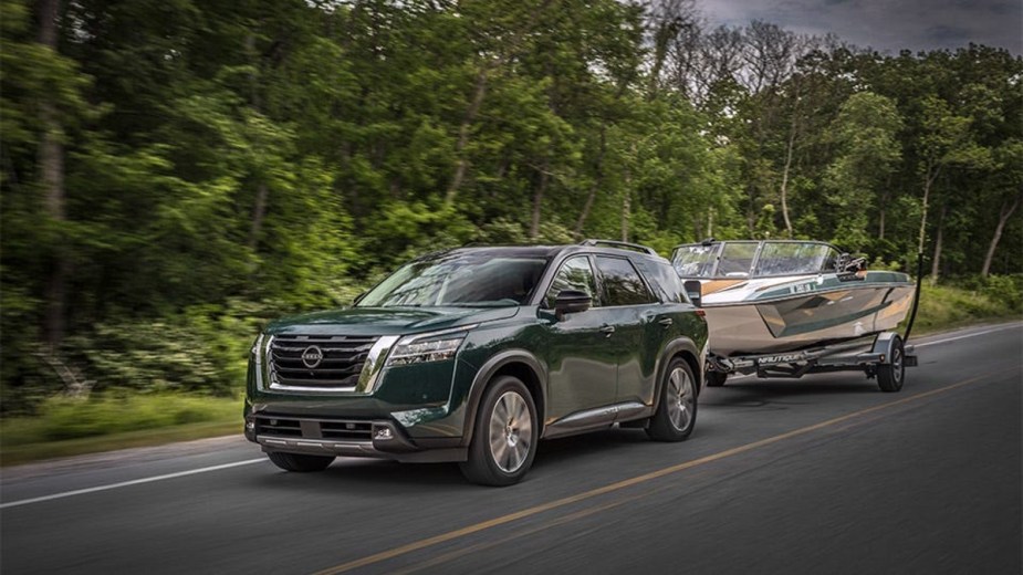 This Green 2022 Nissan Pathfinder is Towing a boat