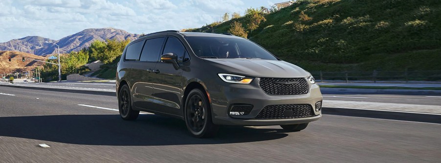 A taupe-colored 2022 Chrysler Pacifica with mountains in the background.