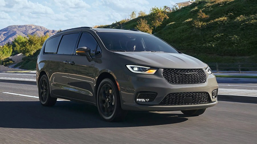 A taupe-colored 2022 Chrysler Pacifica with mountains in the background.