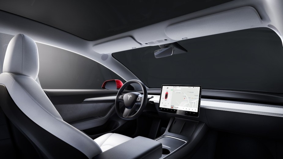 the interior of a 2022 tesla model 3, upgrade the steering wheel for a more unique feeling