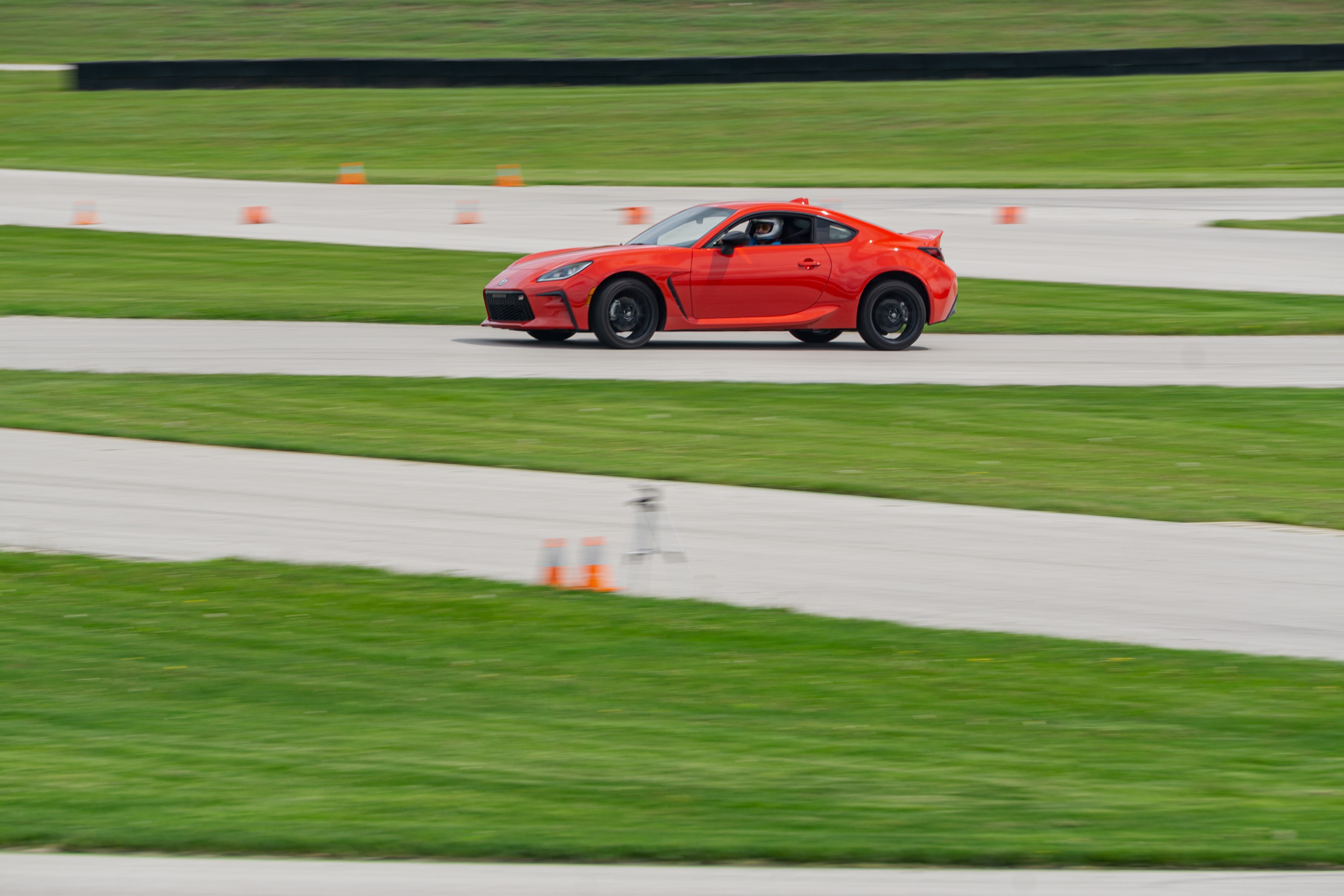 A red 2022 Toyota GR86 Premium taking a corner on Road America's autocross course
