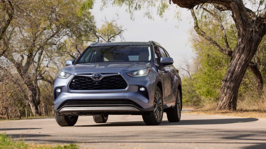 A silver 2022 Toyota Highlander parked in the wilderness, the Highlander is a competitor to the new Honda Pilot