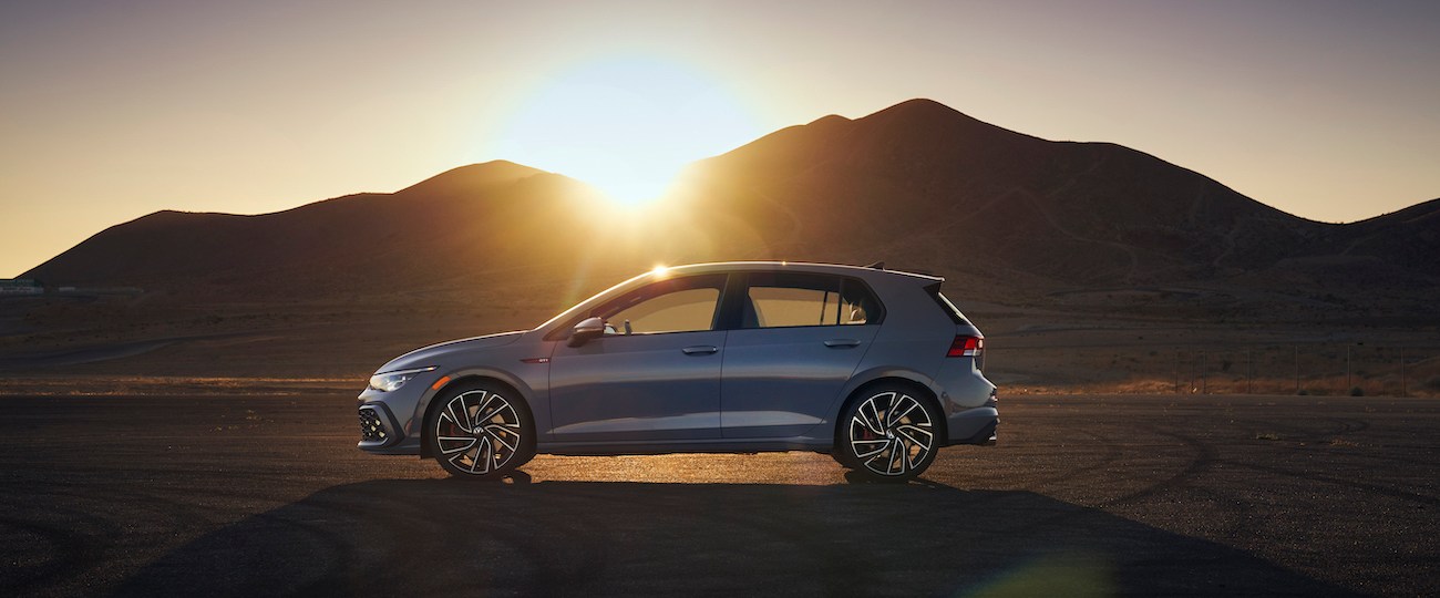 The 2022 Volkswagen GTI side view in the middle of a desert.