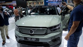 A mint colored Volvo XC40 parked indoors.