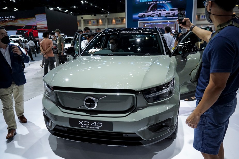 A mint colored Volvo XC40 parked indoors.
