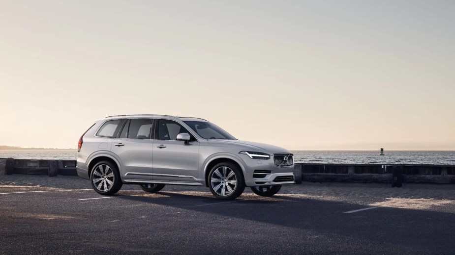 A silver 2022 Volvo XC90 Recharge driving down a highway.