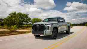 The 2022 Toyota Tundra, a pickup truck with one of the largest fuel tanks, is driving on a road.