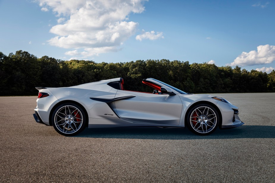 A silver 2023 Chevy C8 Corvette Z06 with an open top parked on a scenic road.