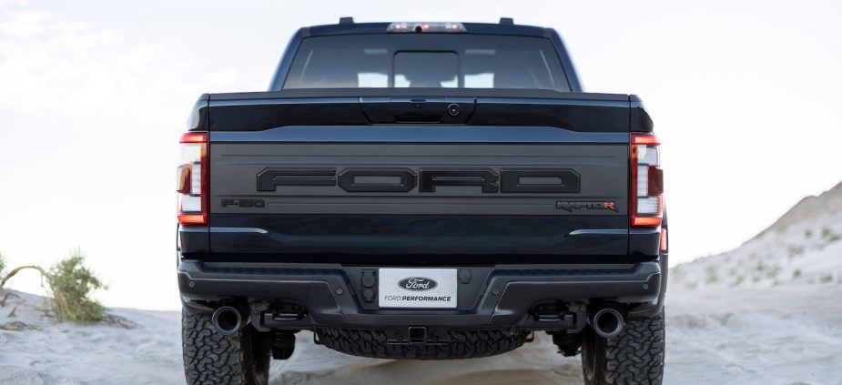 The tailgate of a 2022 Ford Raptor R pickup truck, desert sand visible in the background.
