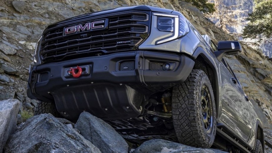 This 2023 GMC Sierra AT4X AEV is crawling over rocks, showing off what an off-road truck should do