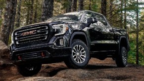A Black 2023 GMC Sierra AT4X in the woods