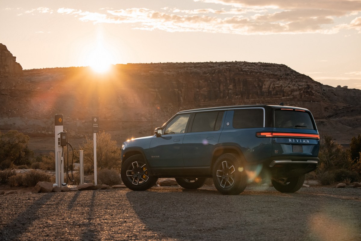 The 2023 Rivian R1S exterior in blue, parked outdoors at dusk