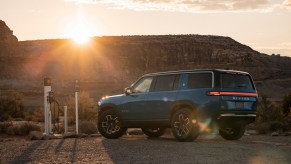 The 2023 Rivian R1S exterior in blue, parked outdoors at dusk
