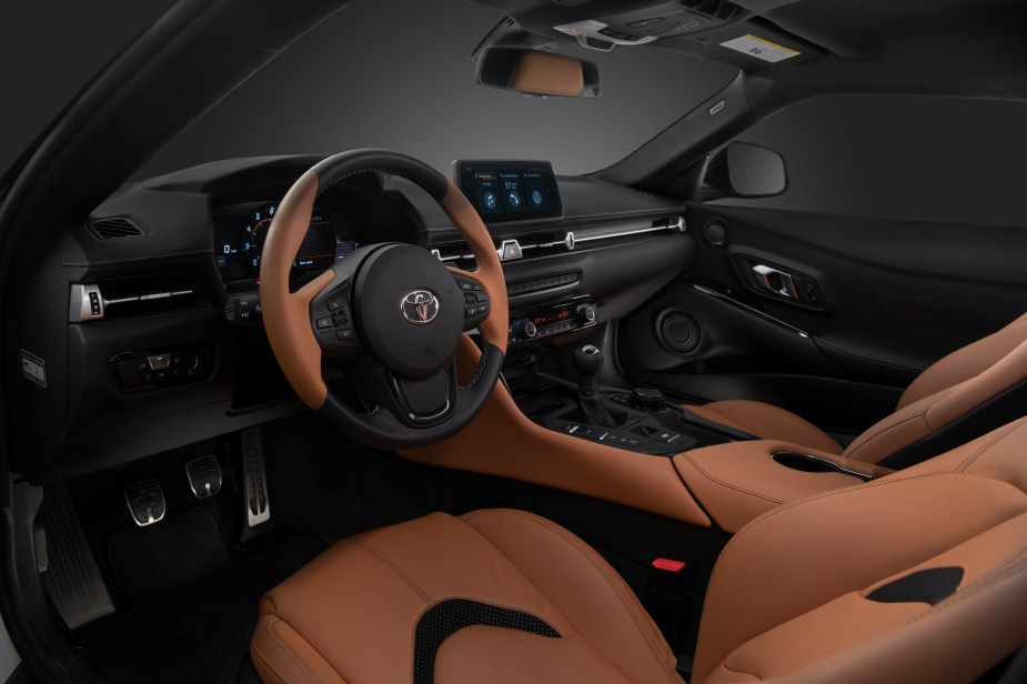 The brown-leather seats and black dashboard of a 2023 Toyota GR Supra MT 3.0