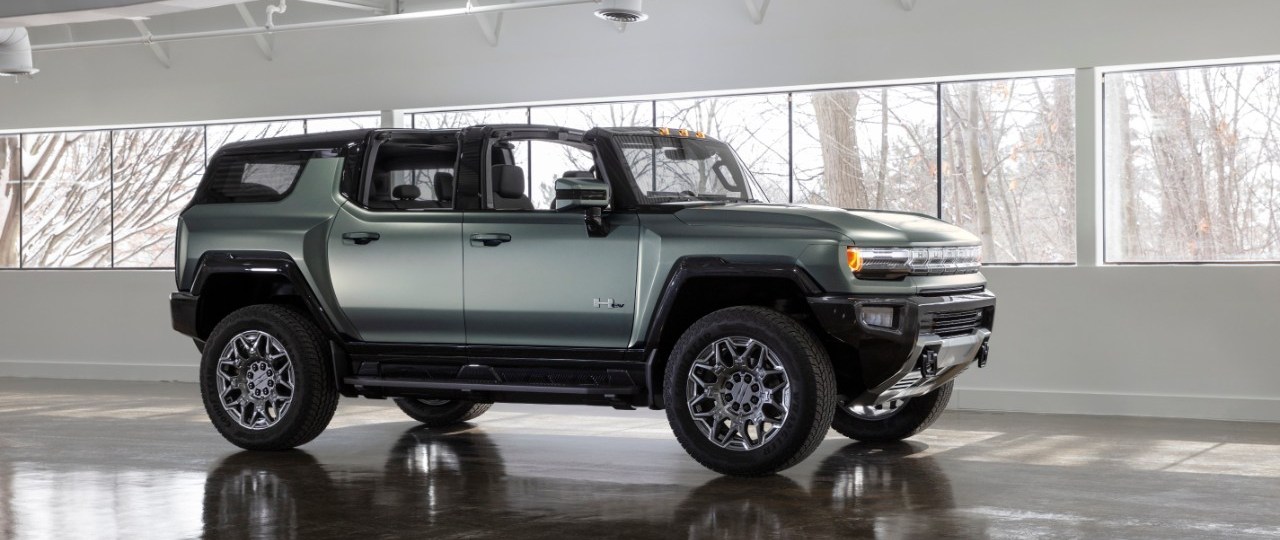 2024 GMC Hummmer EV in green in a showroom
