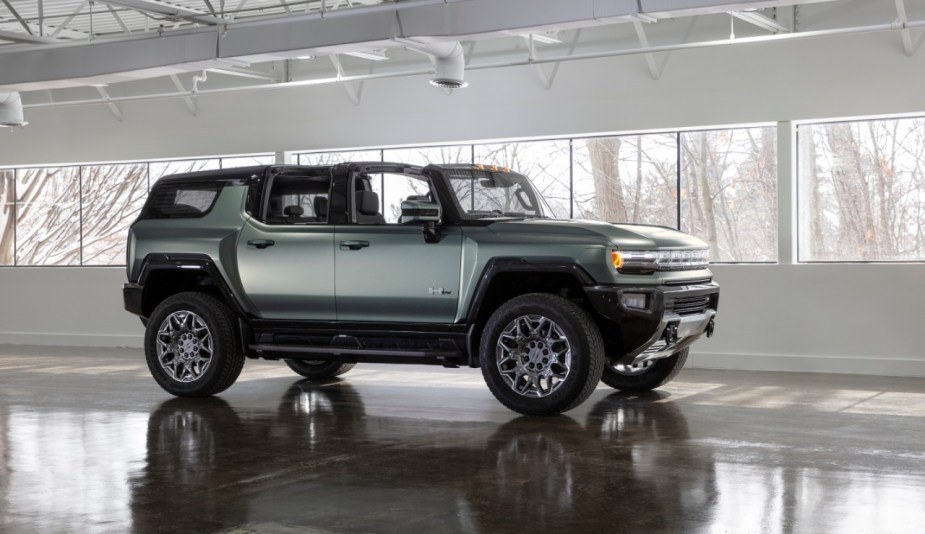 A green Hummer SUV in a showroom. 