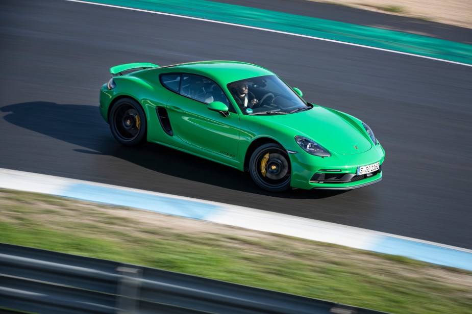 A green 718 Cayman GTS 4.0 driving on the track