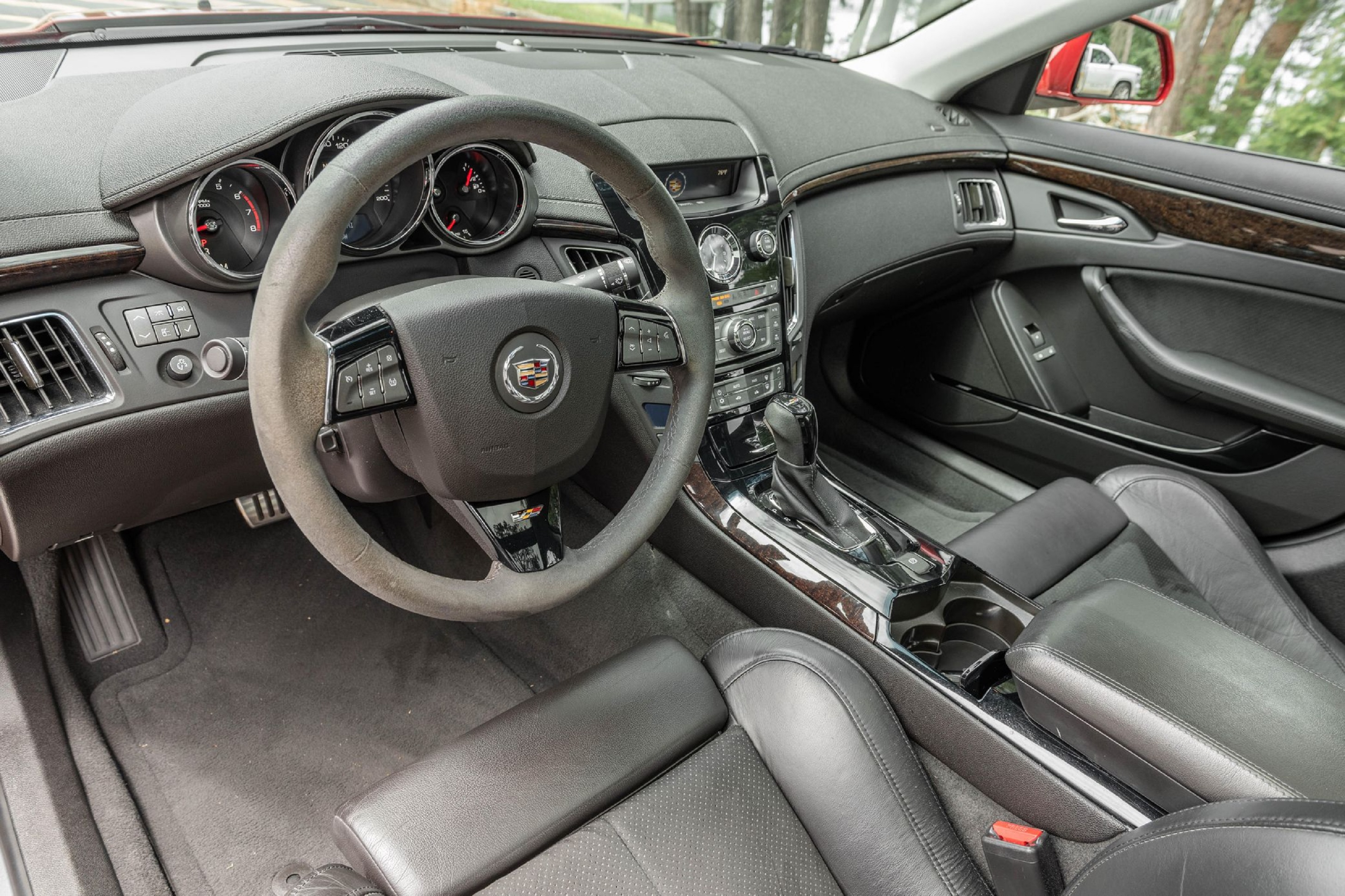 The black-leather front Recaro seats and black dashboard of a 2011 Cadillac CTS-V Sedan