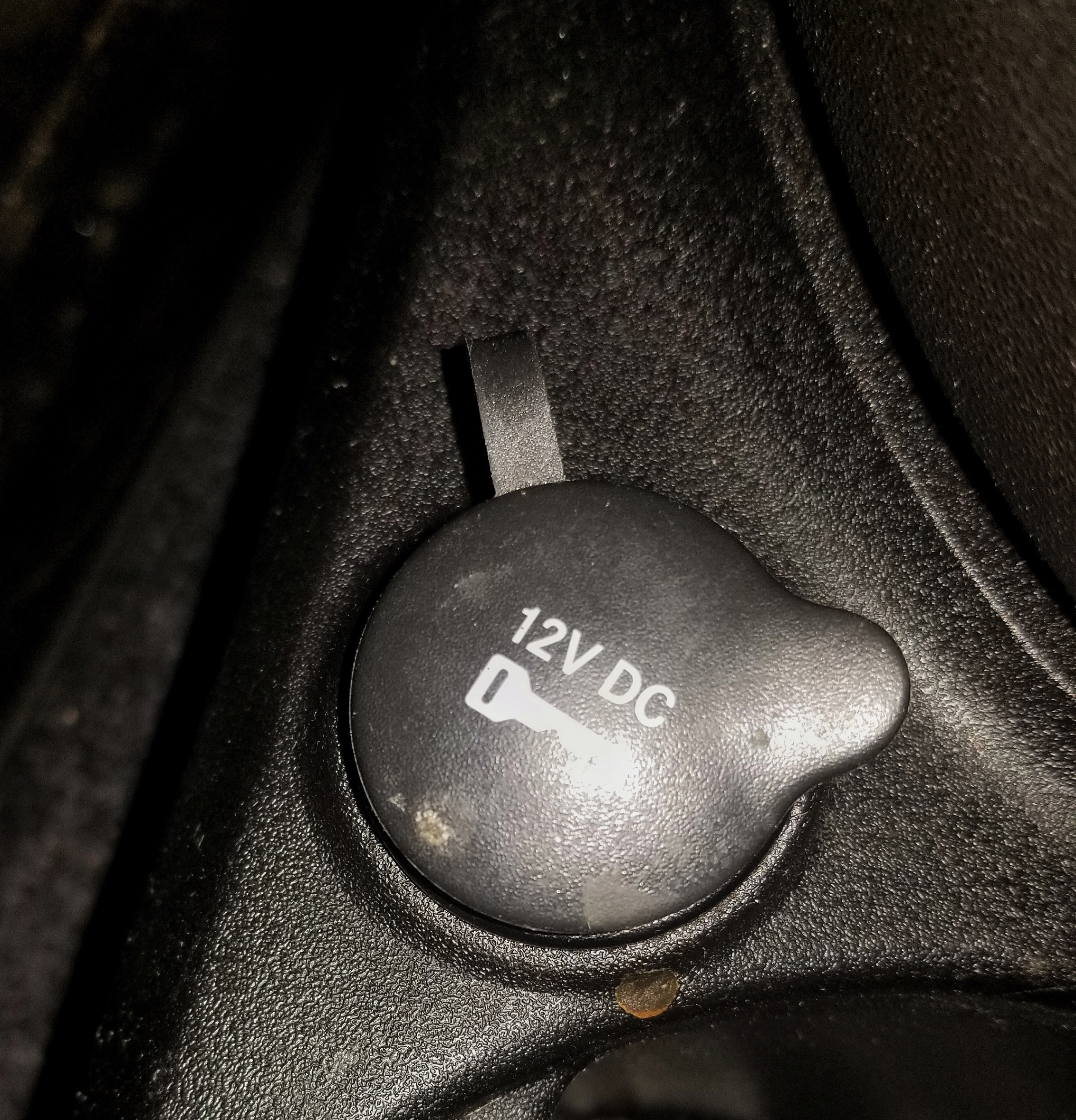 A covered 12-volt car DC power outlet in a 2013 Fiat 500 Abarth