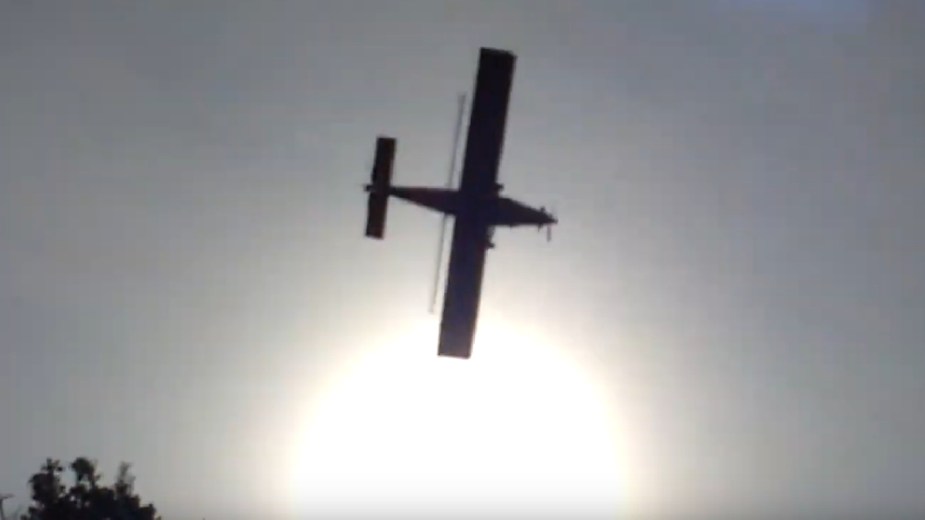 Airplane flying in front of the sun, near EAA AirAdvenure Oshkosh Wittman Field, world's busiest airport