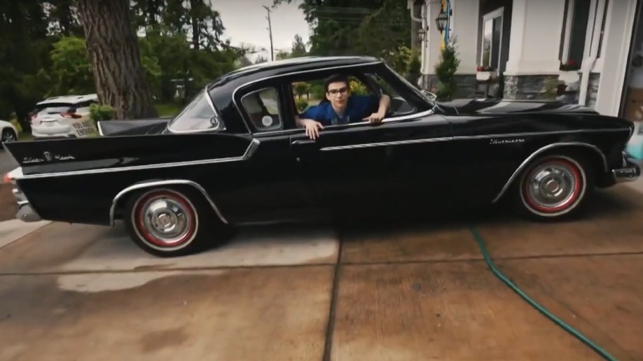 Anthony Schmidt, an autistic boy, sitting in a classic car, highlighting how he creates mind-blowing car photos